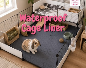 May include: A multi-level wire pet cage featuring a dark gray waterproof cage liner with a quilted pattern. The enclosure includes a white upper loft with a star-patterned mat, a wooden hay feeder, a water bottle, and a brown rabbit.