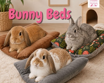 May include: Three rectangular pet beds in brown, grey, and a dark green forest print with red mushrooms, each occupied by a rabbit. The text "Bunny Beds" appears in pink, and a "House and Hounds" logo is visible in the upper right corner.
