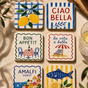May include: A set of six square coasters featuring colourful illustrations. Designs include yellow lemons on a blue grid, the text CIAO BELLA with blue stripes, a table setting with BON APPETIT, a beach scene with la vita è bella, an Amalfi Coast landscape, and a fish with a lemon slice on yellow stripes.