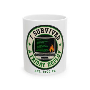 May include: A white ceramic mug featuring a circular graphic with a laptop displaying code, a flame icon, and the text I SURVIVED A FRIDAY DEPLOY EST. 5:00 PM. The design uses black and green colors with a distressed texture inside a circular border.