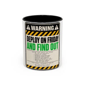 May include: A white ceramic mug with a black interior and rim, featuring a yellow and black hazard warning graphic. The text reads: WARNING DEPLOY ON FRIDAY AND FIND OUT, followed by a list of side effects and the label RISK LEVEL: EXTREMELY FOOLISH.