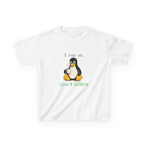 May include: White t-shirt with a cartoon penguin holding a coffee cup. The penguin is black and white with yellow feet. Text above the penguin reads "I run on", and below it, "Linux & Caffeine" in green.