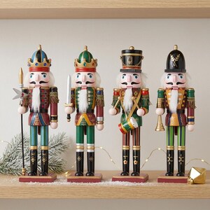May include: Four wooden nutcracker figurines standing in a row. The first wears a blue and red crown and holds a spear. The second wears a green crown and holds a sword. The third wears a black hat and plays a drum. The fourth wears a black helmet and holds a trumpet.