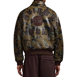 May include: A camouflage bomber jacket with brown detailing. The back displays "AVIREX USA" in brown lettering, with a brown emblem. The jacket has a ribbed hem and cuffs. The jacket is a stylish outerwear piece.