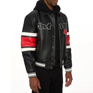 May include: Black leather bomber jacket with red and white striped sleeves. The jacket has the text "Avi" and "re 4" in white lettering. The jacket has a black hood and a white and black striped hem and cuffs.