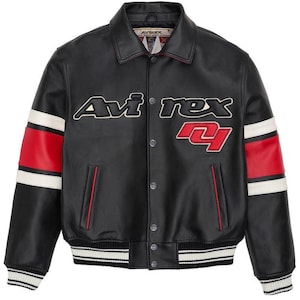 May include: Black leather jacket with the word "Avi rex" in white and red lettering. The jacket has red and white stripes on the sleeves and a ribbed hem and cuffs. The jacket has a button-up front and two front pockets.