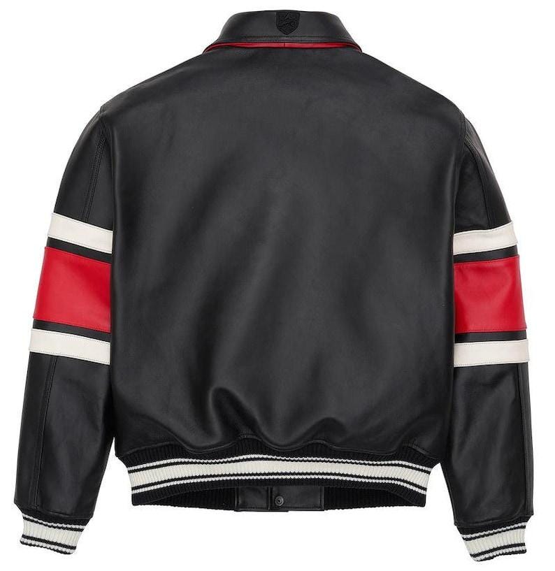 May include: Black leather jacket with red and white striped accents on the sleeves. The jacket has a ribbed knit collar, cuffs, and hem with white stripes. A small emblem is visible on the upper back.