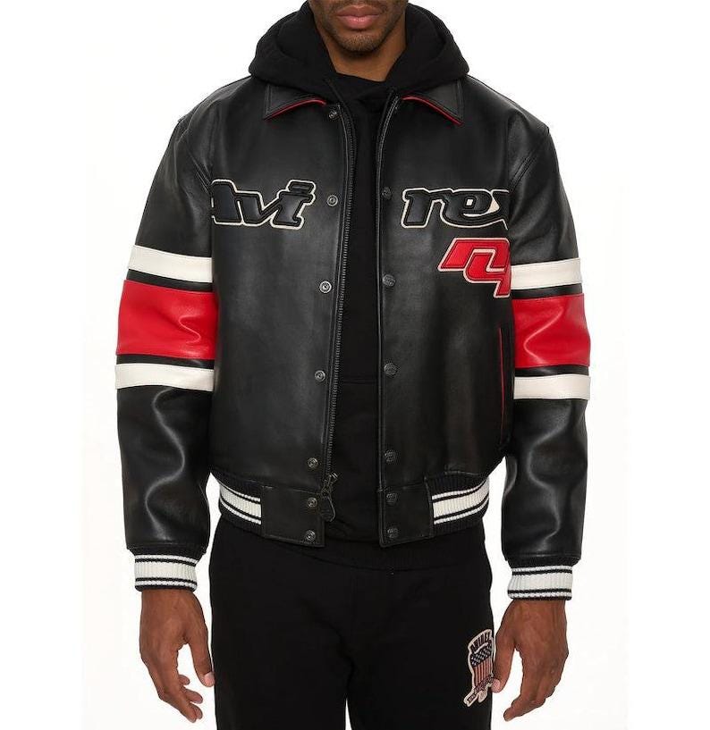 May include: Black leather jacket with red and white accents. The jacket features the text "M" and "rex 4" in white. The sleeves have red and white stripes. The jacket has a button-up front and a ribbed hem and cuffs.