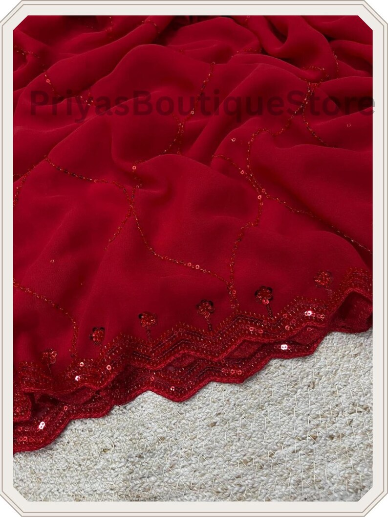 May include: A deep red fabric featuring a scalloped edge with intricate red sequin embroidery. The material is draped in soft folds, and the surface is decorated with delicate, curved lines of matching red sequins. The text PriyasBoutiqueStore is visible.