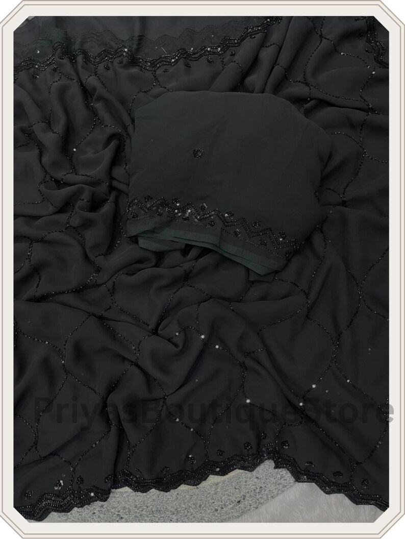May include: A black fabric garment featuring a delicate grid pattern formed by small black beads and scattered sequins. The material has a soft, draped texture with a decorative beaded border along the edge. The text PriyasBoutiqueStore is visible.