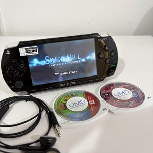 PSP 1000 com 2 UMDs originais e 66 jogos modificados, além de um cartão SD de 64 GB.