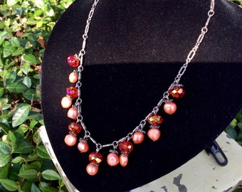 Orange Freshwater Pearls and Orange crystal dangles on a hand linked chain necklace. The Elegance of Jewelry
