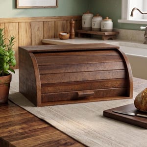 May include: A rectangular wooden bread box with a curved, slatted roll-top lid and a small handle. The box is crafted from dark brown wood with a visible grain, featuring a smooth finish and a sturdy base, designed for countertop storage.