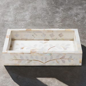 May include: A rectangular tray featuring an iridescent mother-of-pearl inlay. The exterior and interior base are decorated with a delicate, inlaid leaf pattern in shades of white, cream, and soft grey, creating a mosaic effect with smooth edges.
