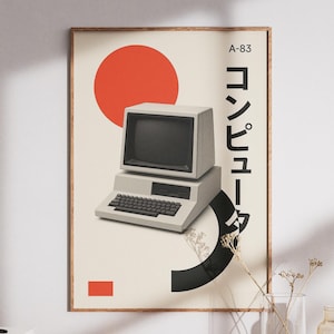 May include: A rectangular wall poster in a wooden frame featuring a beige background, a vintage grey computer, a large red circle, a black curved shape, a small red rectangle, and the text A-83 and Japanese characters for computer.