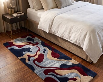 May include: A rectangular area rug featuring a fluid, abstract pattern with organic, interlocking shapes in deep navy blue, burgundy red, and soft beige. The rug has a textured, tufted pile surface and is positioned on a wooden floor.