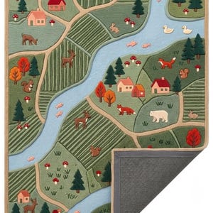May include: A rectangular tufted rug featuring a detailed landscape map with a winding blue river, green fields, and paths. The design includes small houses, evergreen trees, orange-leafed trees, mushrooms, and various animals like deer, foxes, and rabbits.
