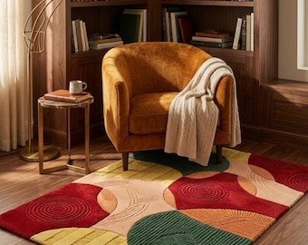 May include: A rectangular area rug featuring a geometric pattern of overlapping circles and semicircles in shades of red, green, yellow, and orange. The rug has a textured, tufted surface with raised circular and linear details throughout the design.