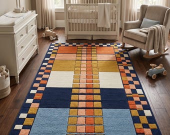 May include: A rectangular area rug featuring a geometric pattern with a central column of alternating orange and peach squares. The rug includes large blocks of navy blue, light blue, mustard yellow, and cream, framed by a checkered border.