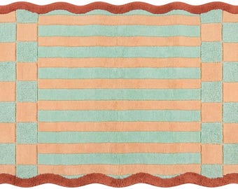 May include: A rectangular rug featuring a central panel of horizontal peach and mint green stripes. The border consists of a checkered pattern in the same colors, finished with a scalloped edge in a solid, deep terracotta red color throughout.