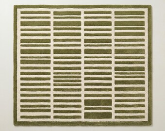 May include: A square area rug featuring a geometric pattern of alternating olive green and cream horizontal bars. The design is organized into four vertical columns separated by thin cream lines, creating a structured, grid-like appearance.