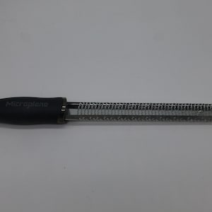 May include: A black Microplane zester with a silver grating surface.