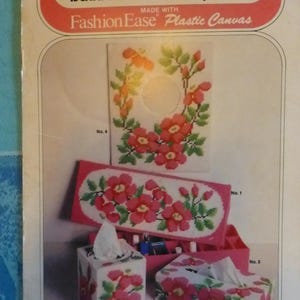 May include: A vintage craft book cover showcasing bathroom accessory ideas using Fashion Ease Plastic Canvas. The cover presents cross-stitch designs of floral patterns on tissue box covers and a rectangular container. The book is labelled "Book 666" and priced at £1.60.