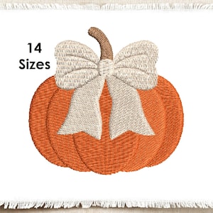 May include: An orange pumpkin machine embroidery design featuring a light beige bow tied around the stem. The text 14 Sizes is printed in black to the left of the pumpkin. The design is displayed on a white fabric square with frayed edges.