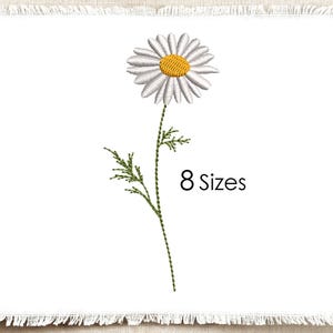 May include: An embroidery design featuring a single daisy with white petals and a yellow center, attached to a green stem with leaves. The text 8 Sizes is printed in black to the right of the flower stem on a white fabric background.