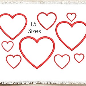 May include: A white fabric square with frayed edges featuring eight red embroidered heart outlines of varying sizes. The text 15 Sizes is printed in black in the centre of the design, positioned between the red heart embroidery patterns.