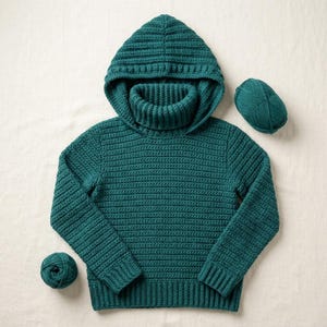 May include: A dark teal long-sleeve hooded jumper featuring a ribbed turtleneck collar and a textured horizontal stitch pattern. The garment is accompanied by two matching balls of yarn, one positioned near the bottom left and one near the top right.