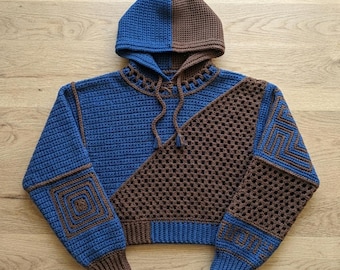 May include: A long-sleeve hooded sweater crafted from blue and brown yarn. The garment features a split-color hood, a diagonal granny square pattern on the front, and square-shaped crochet motifs on the sleeves with ribbed cuffs and hem.