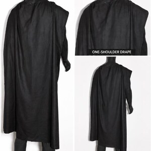 May include: A solid black, floor-length garment featuring a one-shoulder drape design. The fabric hangs loosely from the shoulder, creating a flowing silhouette. The image includes text labels that read ONE-SHOULDER DRAPE and BACK VIEW.