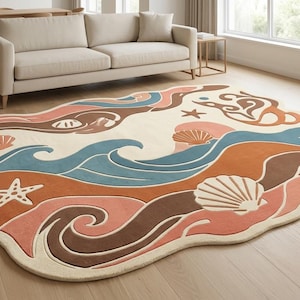 May include: An irregularly shaped area rug featuring a cream background with a wavy, layered design in shades of terracotta, brown, and muted blue. The pattern includes stylized illustrations of seashells and starfish scattered across the surface.