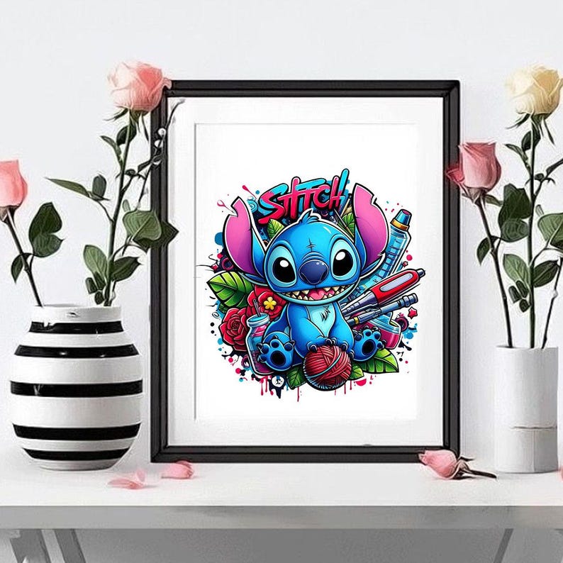 May include: A framed art print featuring a blue alien character with large ears and a wide smile, holding a red ball of yarn. The illustration includes vibrant red roses, green leaves, and the word STITCH in a stylized graffiti-inspired font.