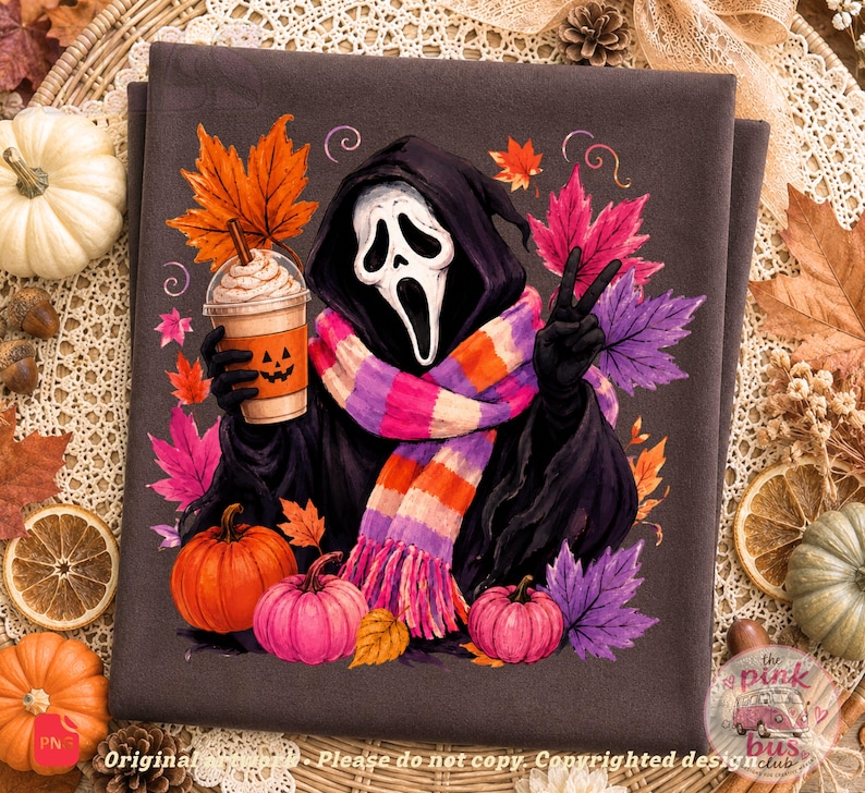 May include: A dark gray fabric featuring a graphic of a hooded figure with a white ghost mask, wearing a pink, orange, and purple striped scarf. The figure holds a coffee cup with a jack-o'-lantern face, surrounded by colorful autumn leaves and pumpkins.