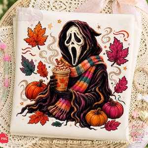 May include: A white fabric square featuring a graphic illustration of a ghost figure in a black hooded robe and a colorful striped scarf, holding a coffee cup. The design includes orange pumpkins, red and orange autumn leaves, and small stars.