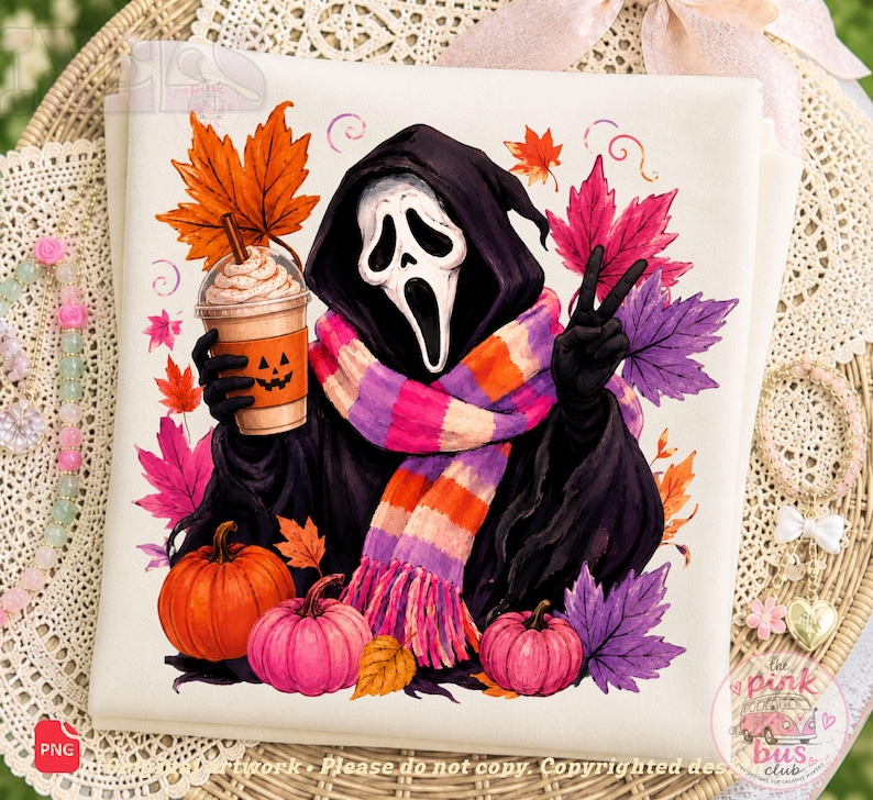 May include: A white fabric square featuring a graphic illustration of a Ghostface character wearing a striped scarf, holding a pumpkin-faced iced coffee cup, and making a peace sign, surrounded by colorful autumn leaves and three pumpkins.