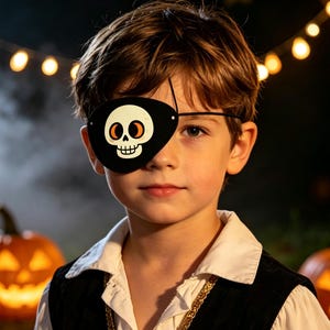 May include: A black eye patch featuring a white cartoon skull graphic with orange eye sockets. The patch is secured with a thin black elastic strap, designed to cover one eye, and is worn as part of a pirate-themed costume accessory.
