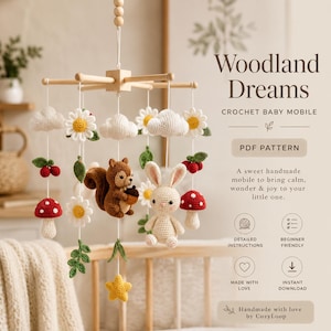 May include: A crochet baby mobile with a woodland theme, featuring a squirrel, rabbit, mushrooms, daisies, clouds, and berries. The mobile is suspended from a wooden frame. The text "Woodland Dreams" is included.