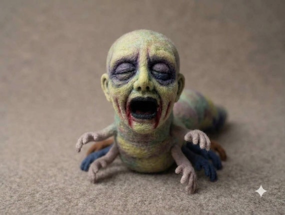 A hand-needle-felted wool sculpture of a genuinely unsettling creature — the kind of weird, one-of-a-kind art object that stops visitors dead in their tracks.