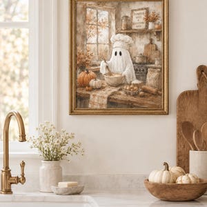 May include: A framed wall art print depicting a ghost wearing a chef hat and mixing ingredients in a bowl within a rustic kitchen. The scene includes pumpkins, a bag of flour, and a sign on the wall that reads Pumpkin Spice & Everything Nice.