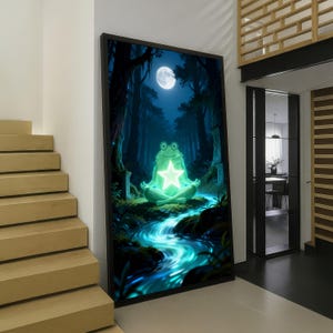 May include: A framed vertical wall art print depicting a green frog sitting in a meditative pose on a mossy bank beside a glowing blue stream. A bright white star shines on the frog's chest under a full moon in a dark forest setting.