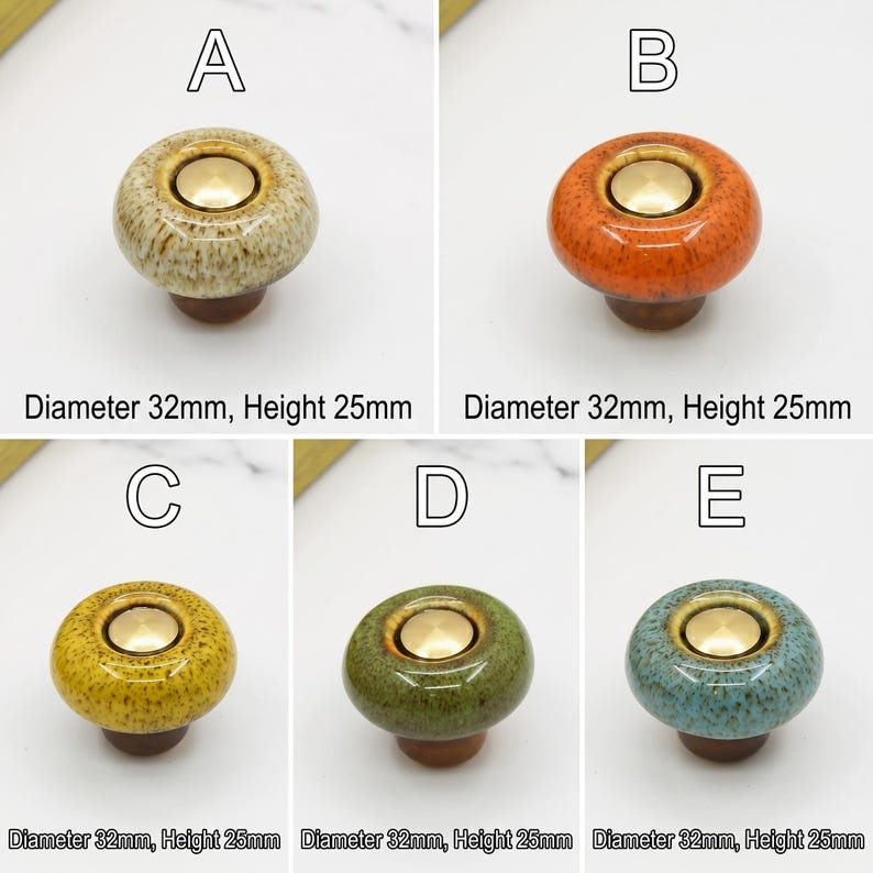 May include: Five round ceramic cabinet knobs labeled A through E, each featuring a glossy speckled glaze in beige, orange, yellow, green, or blue with a central gold-tone metal disc. Each knob has a diameter of 32mm and a height of 25mm.
