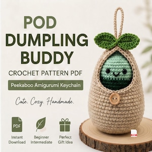 May include: A crochet pattern PDF titled POD DUMPLING BUDDY featuring a beige crocheted pod with two green leaves on top and a small wooden button. Inside the pod sits a small green amigurumi character with black eyes and a stitched smile.