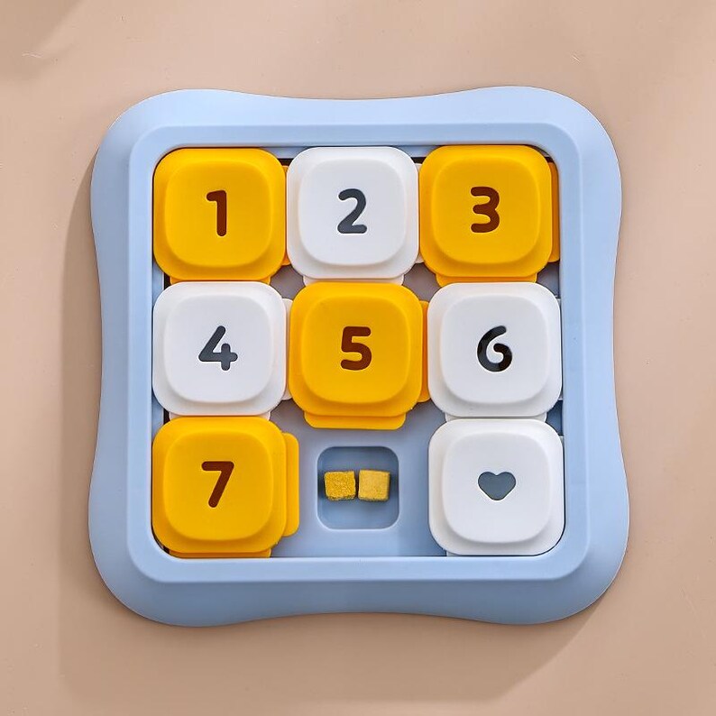 May include: A blue square puzzle with nine numbered and shaped pieces. The pieces are yellow and white, with numbers 1 to 7, two small square pieces, and a heart shape. The puzzle is designed for children.