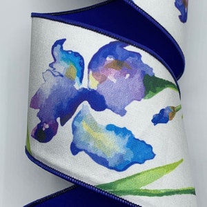 May include: White satin ribbon with a blue watercolor iris design and a royal blue edge. The ribbon is 2.5 inches wide.