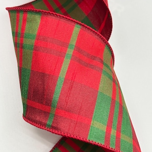 May include: Red and green plaid ribbon with a wired edge. The ribbon is perfect for adding a festive touch to your holiday crafts and decorations.