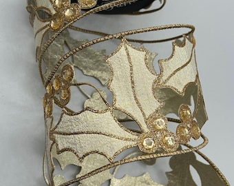 May include: Gold and ivory ribbon with a cut-out design of holly leaves and berries. The berries are embellished with gold glitter.