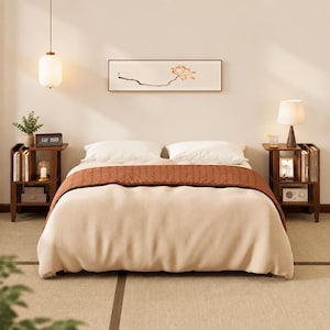 May include: A bedroom set featuring a bed with a cream-colored duvet and a rust-colored runner, flanked by two dark wood nightstands with open shelving. Above the bed hangs a horizontal framed print of a lotus flower and a white pendant light.